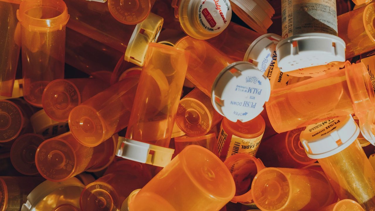 Pile of orange prescription bottles